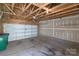Spacious garage with concrete floor and unfinished walls perfect for storage and parking at 1027 Writers Way, Cornelius, NC 28031
