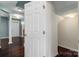 Hallway with hardwood floors and white trim, leading to an open floorplan at 1027 Writers Way, Cornelius, NC 28031