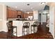 An eat-in kitchen features granite counters, tiled backsplash and dark wood cabinets at 1027 Writers Way, Cornelius, NC 28031