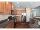Updated kitchen with stainless steel appliances, granite countertops, and wood cabinetry at 1027 Writers Way, Cornelius, NC 28031