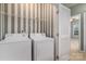 Convenient laundry room with modern washer and dryer and striped accent wall at 1027 Writers Way, Cornelius, NC 28031