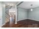 Living room with hardwood floors, staircase, and connection to the kitchen area at 1027 Writers Way, Cornelius, NC 28031