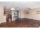 Open-concept living area combines kitchen and living space with sleek hardwood floors at 1027 Writers Way, Cornelius, NC 28031
