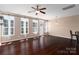 Spacious living room features hardwood flooring, a ceiling fan, and ample natural light at 1027 Writers Way, Cornelius, NC 28031