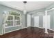 Spacious living room featuring hardwood floors, ample natural light, and architectural columns at 1027 Writers Way, Cornelius, NC 28031