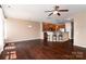 Living room features dark hardwood floors, ceiling fan and open layout at 1027 Writers Way, Cornelius, NC 28031