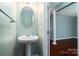 Compact powder room with a pedestal sink and modern fixtures at 1027 Writers Way, Cornelius, NC 28031