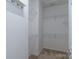 Spacious walk-in closet with wire shelving offers ample storage space in this home at 1027 Writers Way, Cornelius, NC 28031