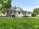 Back exterior of home with a grassy yard, deck, grill, and plenty of space for outdoor activities at 1102 Lane St, Kannapolis, NC 28083