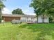 Large backyard featuring a deck with patio furniture, fire pit with seating, and plenty of green space at 1102 Lane St, Kannapolis, NC 28083