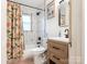 Bathroom featuring stylish vanity, shower/tub combo with modern tile, and a shower curtain at 1102 Lane St, Kannapolis, NC 28083