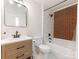 Bathroom with white cabinets, a white toilet, and a shower/tub combo with brick accent wall at 1102 Lane St, Kannapolis, NC 28083