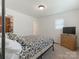 A bright bedroom features a decorative comforter and a wooden dresser with a TV at 1102 Lane St, Kannapolis, NC 28083