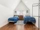 Cozy bedroom featuring an angled ceiling, two twin beds, hardwood floors, and natural lighting at 1102 Lane St, Kannapolis, NC 28083