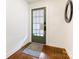 Bright entryway featuring wood floors, a stylish area rug, and a door with glass panes at 1102 Lane St, Kannapolis, NC 28083