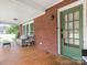 Inviting covered front porch featuring seating, a wooden deck, and a view of the landscaped yard at 1102 Lane St, Kannapolis, NC 28083