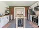 Eat-in kitchen featuring stainless appliances, white cabinets, a center island, and red brick accent wall at 1102 Lane St, Kannapolis, NC 28083