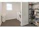 A well-lit laundry room features white washer and dryer with black wire shelving unit at 1102 Lane St, Kannapolis, NC 28083