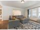 Bright living room featuring a comfortable gray sofa, area rug, and plenty of natural light at 1102 Lane St, Kannapolis, NC 28083