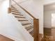 Staircase with wood treads and white risers with modern metal railing at 1102 Lane St, Kannapolis, NC 28083