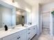 Bathroom with double vanity, quartz countertops, and a separate shower and walk-in closet at 11021 Warfield Ave # 03, Huntersville, NC 28078