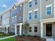 Attractive townhouse with gray siding, white trim, brick accents and well-kept lawn at 11021 Warfield Ave # 03, Huntersville, NC 28078