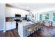 Modern kitchen with white cabinets, stainless steel appliances, and a spacious island with seating at 11021 Warfield Ave # 03, Huntersville, NC 28078