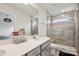 Modern bathroom with glass-enclosed shower, quartz countertop, dual sinks, and great lighting at 13323 Savaine St, Charlotte, NC 28278