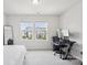Bright bedroom features two windows, a desk, and a mirror, creating a comfortable and functional space at 13323 Savaine St, Charlotte, NC 28278