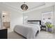 Spacious bedroom with tray ceiling, recessed lighting, carpeted floors, and a view of the backyard at 13323 Savaine St, Charlotte, NC 28278