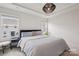 Bright bedroom featuring a large bed, modern decor, and two windows for ample natural light at 13323 Savaine St, Charlotte, NC 28278
