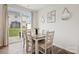 Bright dining area with modern decor, a table with seating for six, and sliding glass doors to the backyard at 13323 Savaine St, Charlotte, NC 28278