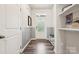 Welcoming entryway with paneled wall, wood floors, and practical shelving at 13323 Savaine St, Charlotte, NC 28278