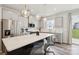 Bright kitchen features stainless steel appliances, shaker cabinets, and a large island with bar seating at 13323 Savaine St, Charlotte, NC 28278