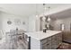 Kitchen/dining area with a dark grey island with a white countertop and pendant lights above the island at 13323 Savaine St, Charlotte, NC 28278