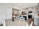 Open-concept kitchen has stainless appliances, white cabinets, a dark island, and pendant lighting at 13323 Savaine St, Charlotte, NC 28278
