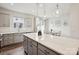 A bright kitchen with gray cabinets and white quartz countertops opens to the dining area at 13323 Savaine St, Charlotte, NC 28278
