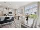 The open kitchen features white and gray cabinetry, stainless steel appliances, and a backyard view at 13323 Savaine St, Charlotte, NC 28278