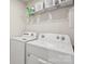 Well-equipped laundry room with modern washer, dryer, wire shelf storage, and bright lighting at 13323 Savaine St, Charlotte, NC 28278