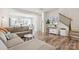 Comfortable living room features hardwood flooring and staircase to second floor at 13323 Savaine St, Charlotte, NC 28278