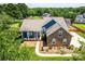 Aerial view of brick and siding home with covered front porch at 13733 Castleford Dr, Mint Hill, NC 28227