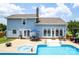 Backyard showcasing a pool, patio, hot tub, and a well-maintained lawn at 13733 Castleford Dr, Mint Hill, NC 28227