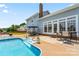 Backyard features a pool, a hot tub, and an expansive patio for outdoor gatherings at 13733 Castleford Dr, Mint Hill, NC 28227