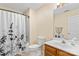 Bathroom with a shower-tub combination, toilet, vanity, and a decorative shower curtain at 13733 Castleford Dr, Mint Hill, NC 28227