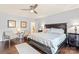 Spacious bedroom with dark wood floors, ceiling fan, and neutral decor at 13733 Castleford Dr, Mint Hill, NC 28227