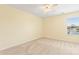 Bright bedroom with a neutral carpet, ceiling fan, and a window offering natural light at 13733 Castleford Dr, Mint Hill, NC 28227