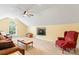 Bonus room with neutral carpet, a ceiling fan, a comfortable seating area, and a TV at 13733 Castleford Dr, Mint Hill, NC 28227