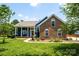 Beautiful brick and siding home with manicured lawn and welcoming front porch at 13733 Castleford Dr, Mint Hill, NC 28227