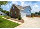 Two-story home exterior with attached garage and landscaping at 13733 Castleford Dr, Mint Hill, NC 28227