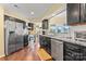 Well-equipped kitchen with stainless steel appliances, dark cabinets, and modern countertops at 13733 Castleford Dr, Mint Hill, NC 28227